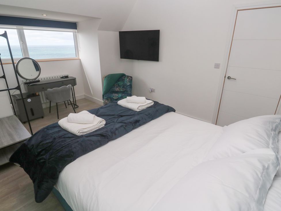 A bedroom with a bed and desk at Shearwater