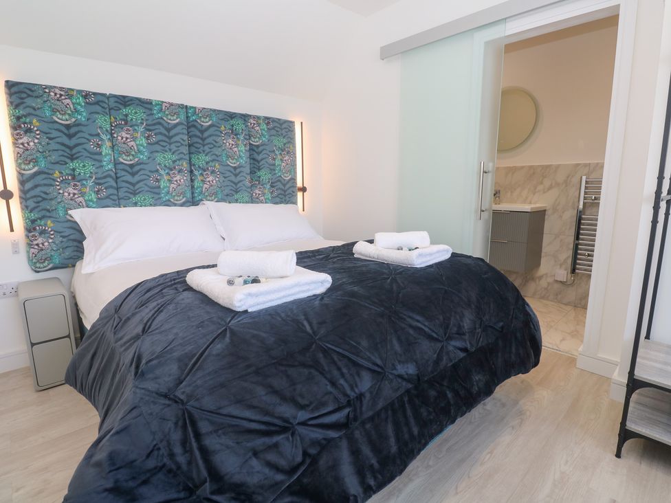 A bedroom with a bed and towels on it at Shearwater
