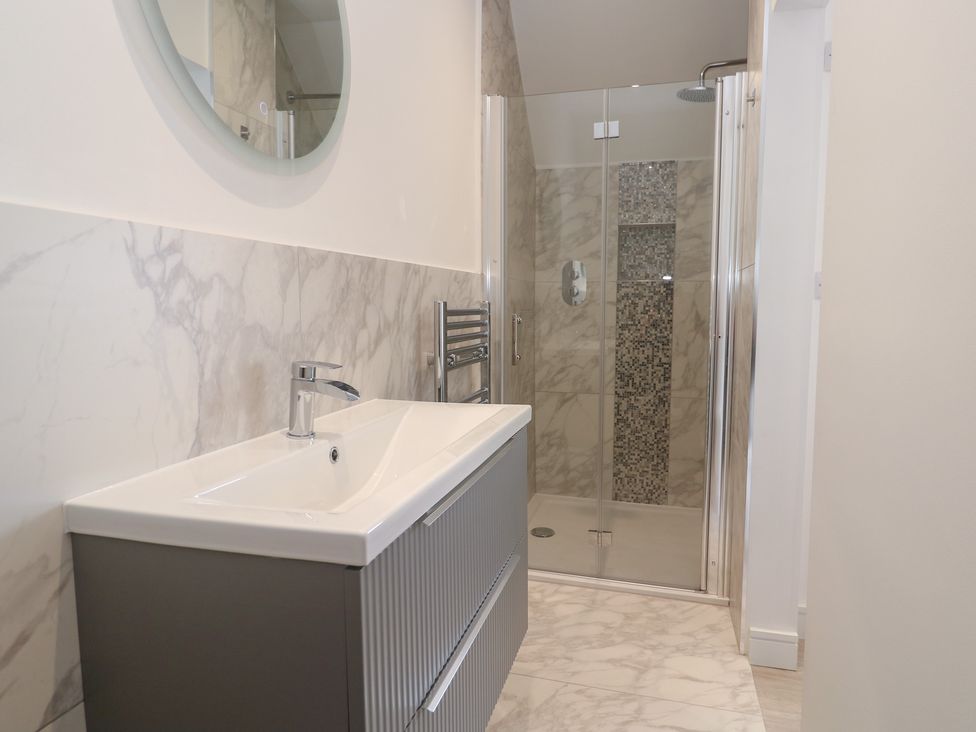A bathroom with a sink and shower at Shearwater