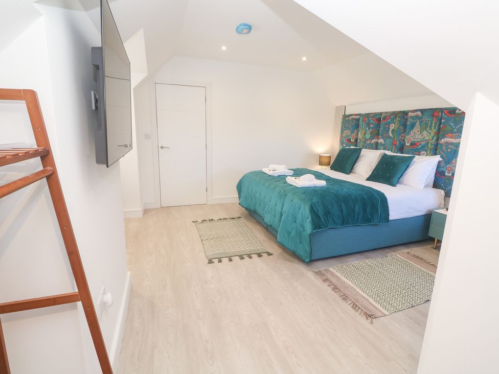 A bedroom with a bed and TV at Shearwater
