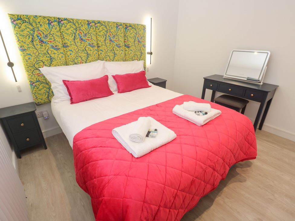 A bedroom with a bed and desk at Shearwater