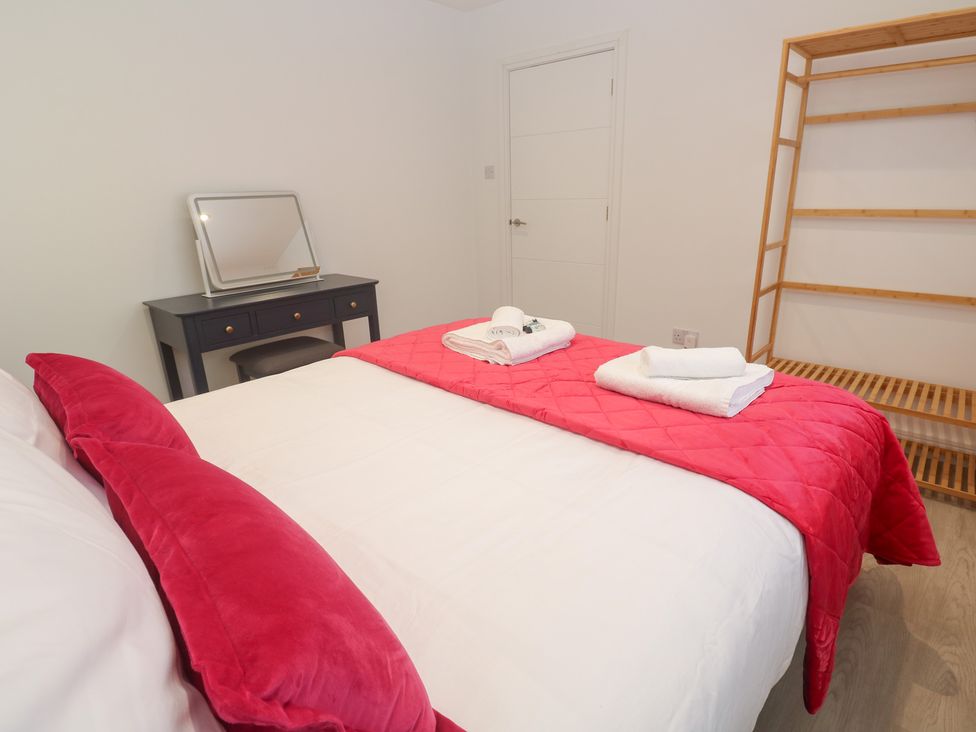 A bedroom with a bed and dresser at Shearwater