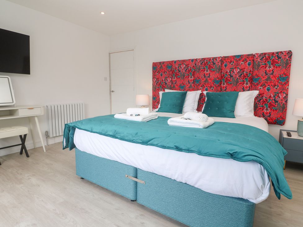 A bedroom with a bed and a television at Shearwater