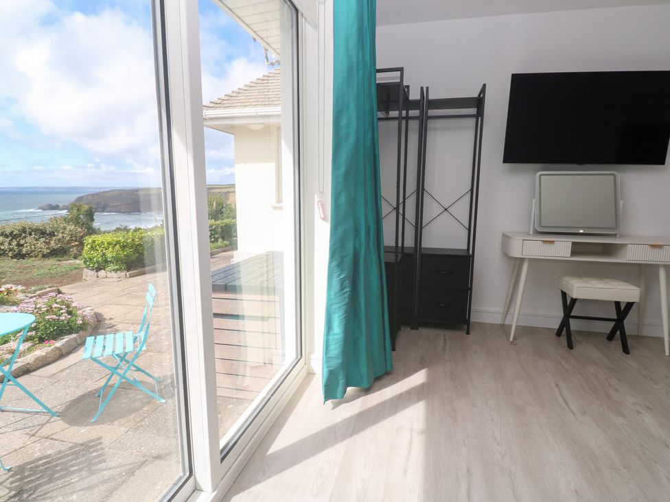 A bedroom with a dresser and television at Shearwater