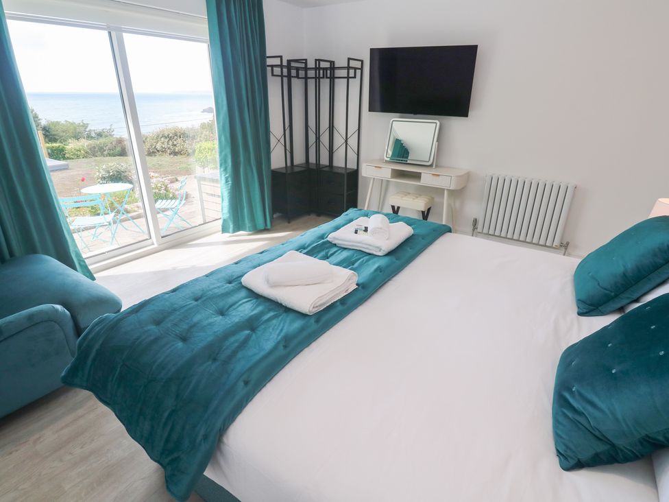A bedroom with a bed and sofa at Shearwater