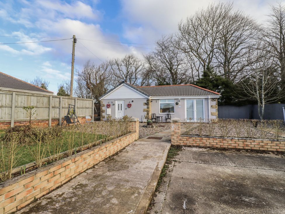 A house with a pathway and fencing at Old Colliery Cottage Shilbottle