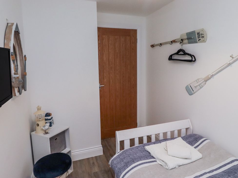 A bedroom with a bed and decorative items at Old Colliery Cottage in Shilbottle