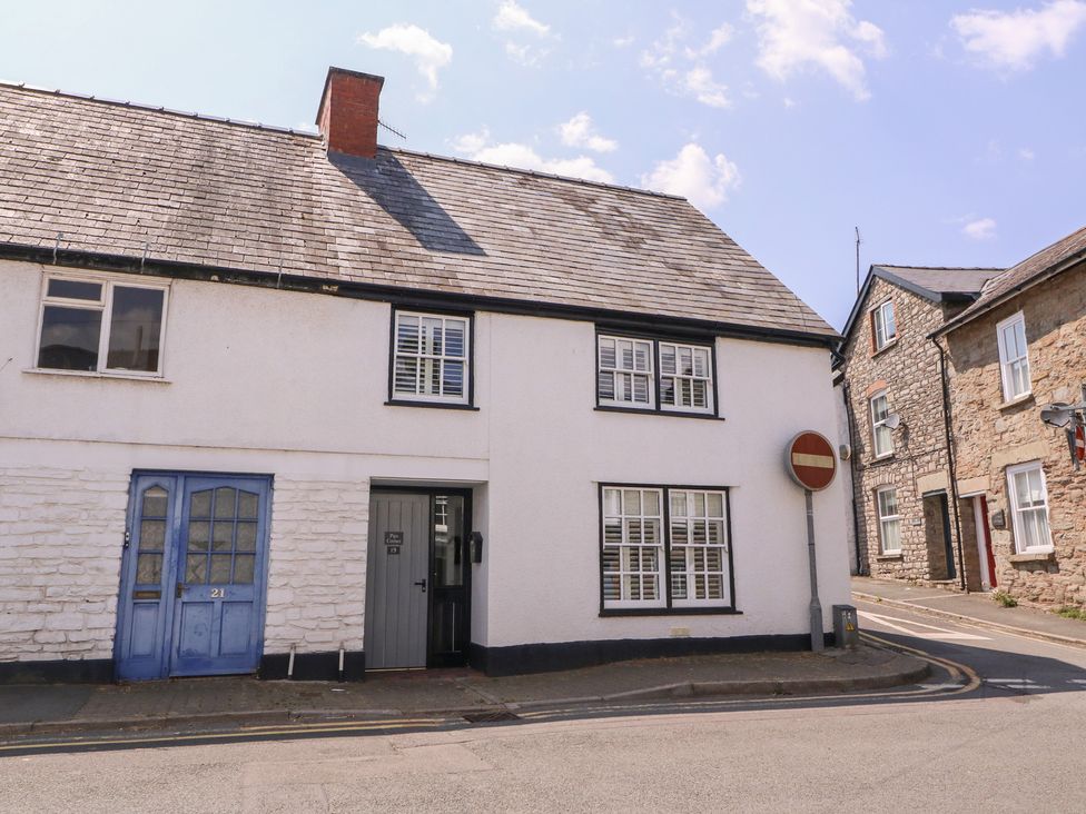 A house with a blue door and a road sign at 19 Lion Street Hay-On-Wye