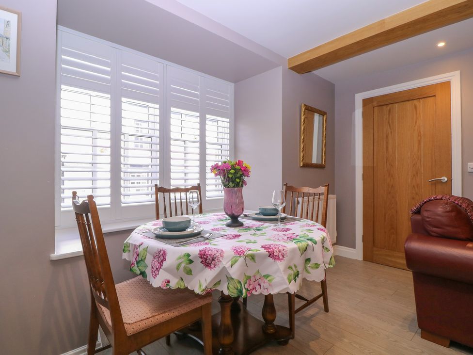 A dining room with a table set for two at 19 Lion Street Hay-On-Wye