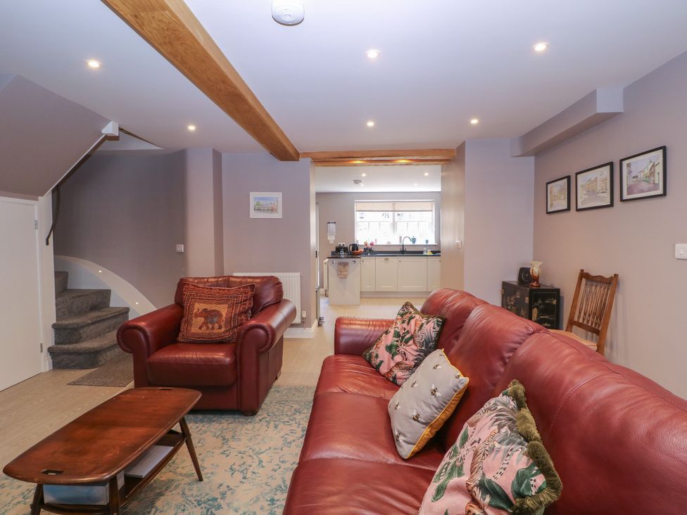 A living room with a sofa and staircase at 19 Lion Street Hay-On-Wye