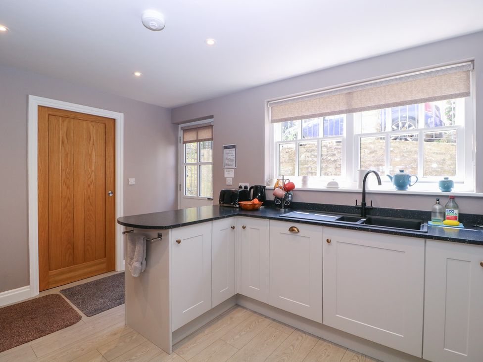 A kitchen with sink and appliances at 19 Lion Street Hay-On-Wye