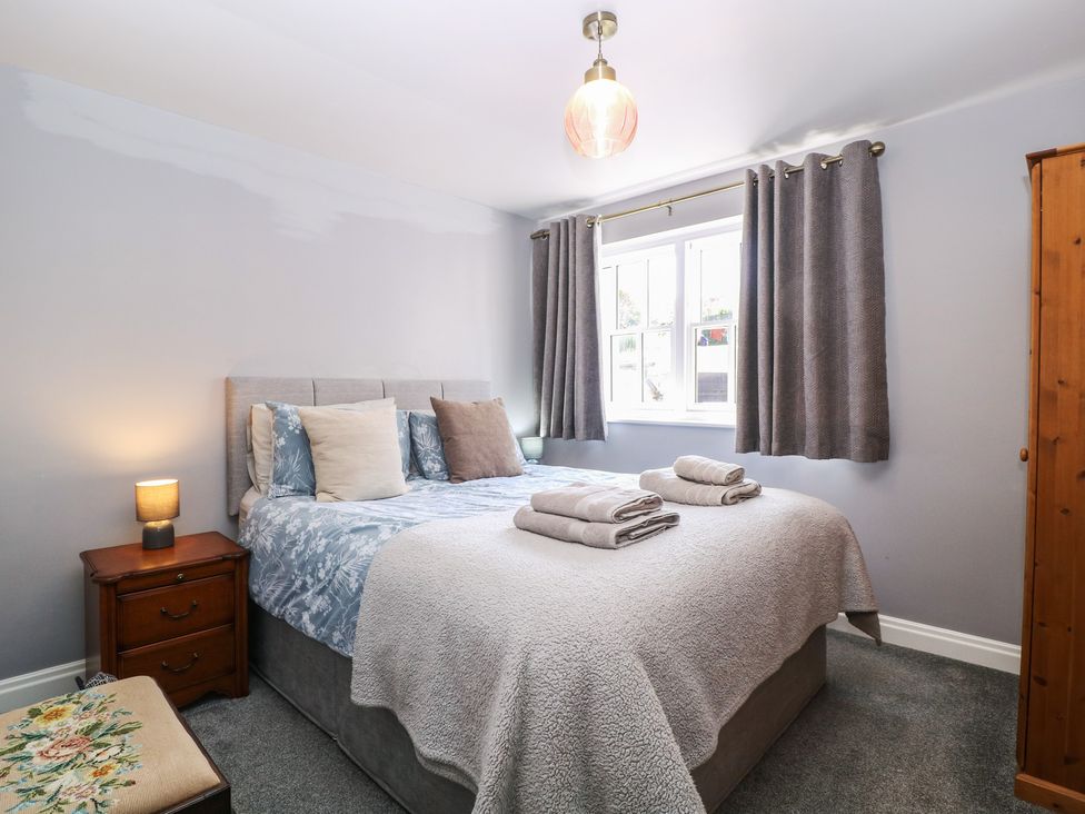 A bedroom with a bed and bedside table at 19 Lion Street Hay-On-Wye