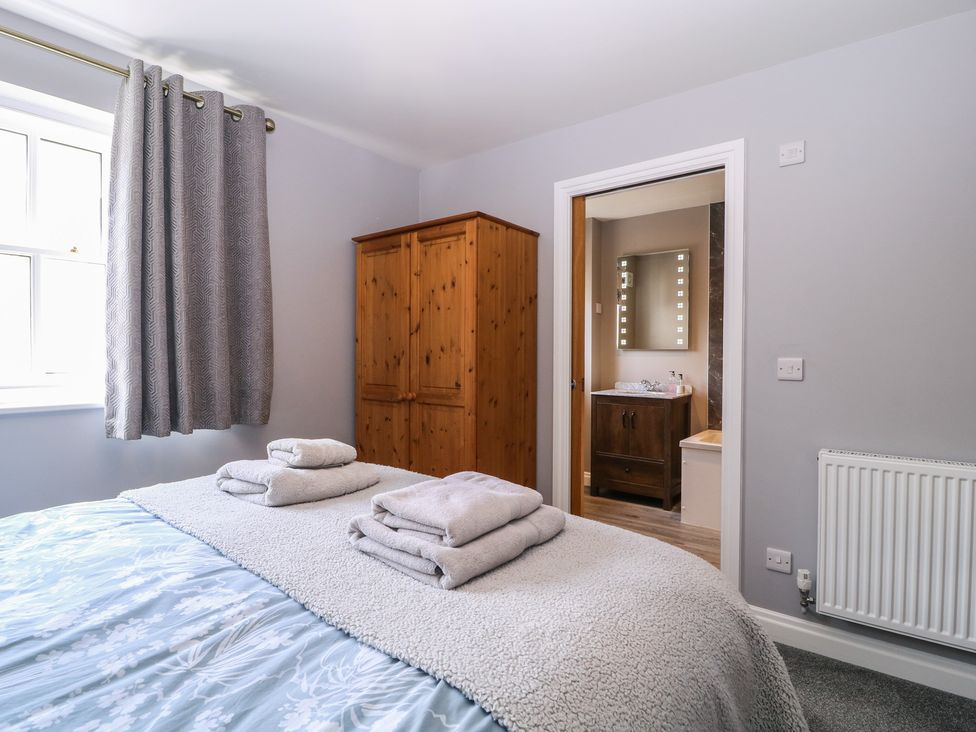 A bedroom with bed and wardrobe at 19 Lion Street Hay-On-Wye