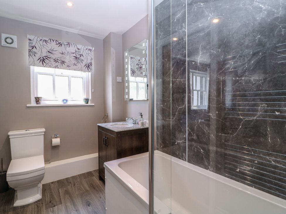 A bathroom with a bathtub and sink at 19 Lion Street in Hay-On-Wye