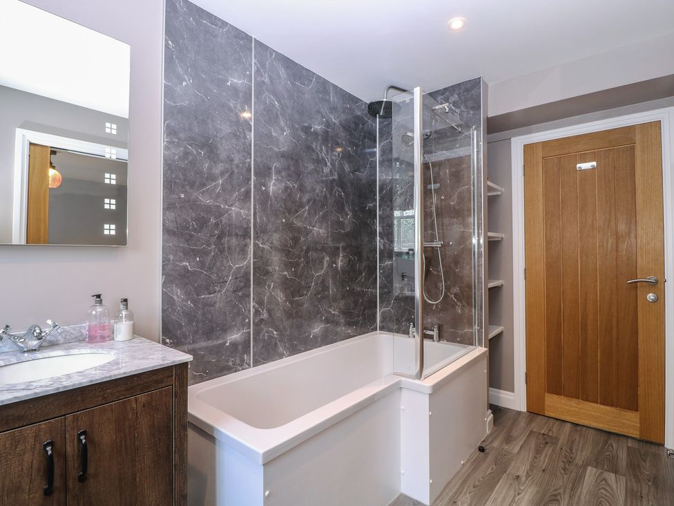 A bathroom with a shower and bathtub at 19 Lion Street Hay-On-Wye
