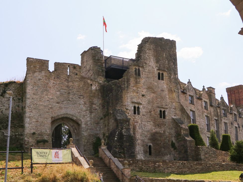 A stone castle with a flag at 19 Lion Street Hay-On-Wye