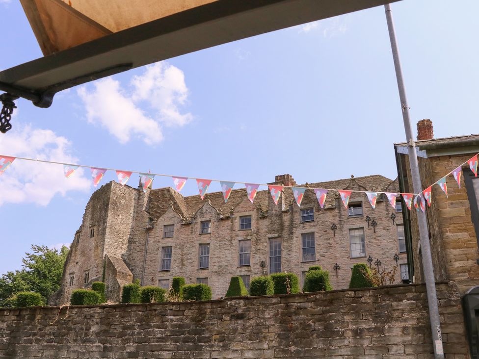 A historical building with bunting and greenery at 19 Lion Street Hay-On-Wye