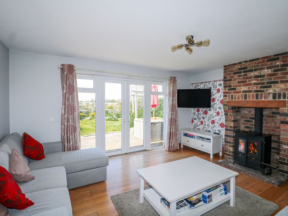 A living room with a sofa and a fireplace at 50 Harbour Road in Pagham