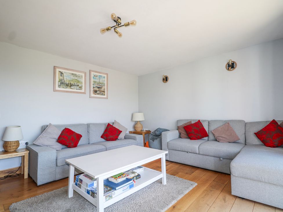 A living room with sofas and a coffee table at 50 Harbour Road in Pagham