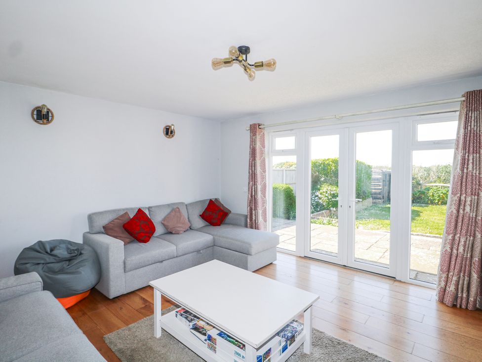 A living room with a sofa and coffee table at 50 Harbour Road in Pagham