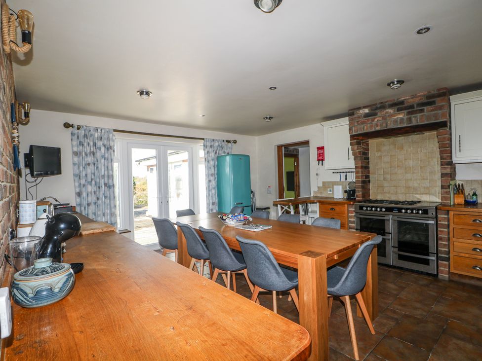 A kitchen with a table and chairs at 50 Harbour Road in Pagham