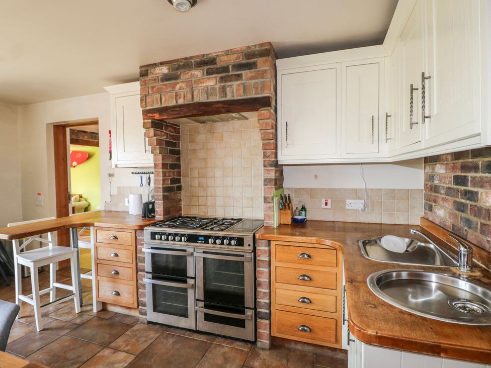 A kitchen with cabinets and stove at 50 Harbour Road in Pagham