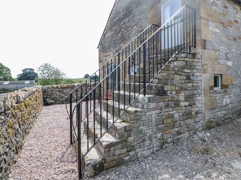 Stairs leading to a door with a railing at The Coach House at Mayfurlong Farm Grindon near Waterhouses