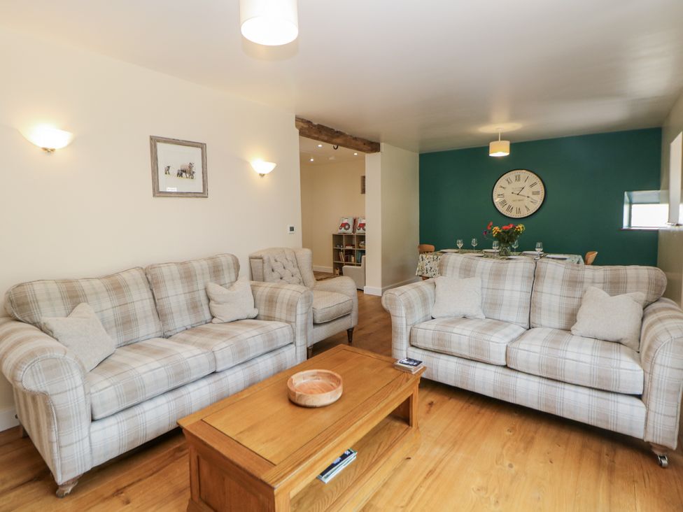 A living room with sofas and a coffee table at The Coach House at Mayfurlong Farm Grindon near Waterhouses