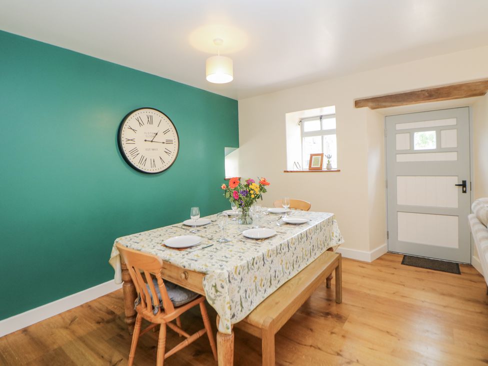 A dining room with a table and chairs at The Coach House at Mayfurlong Farm Grindon near Waterhouses