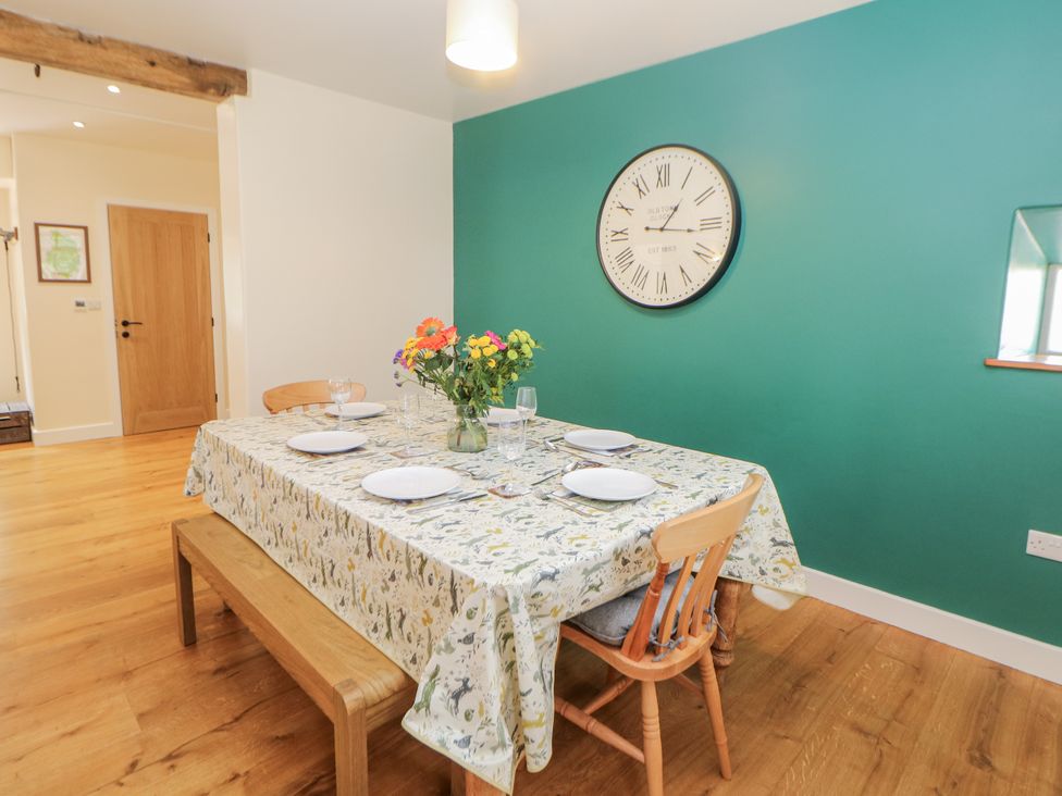 A dining room with a table set for six at The Coach House at Mayfurlong Farm Grindon near Waterhouses