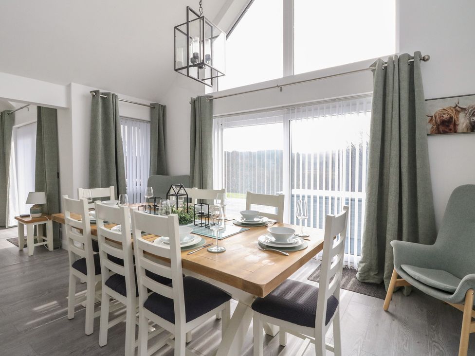 A dining room with a table and chairs at Eildan in Fort William