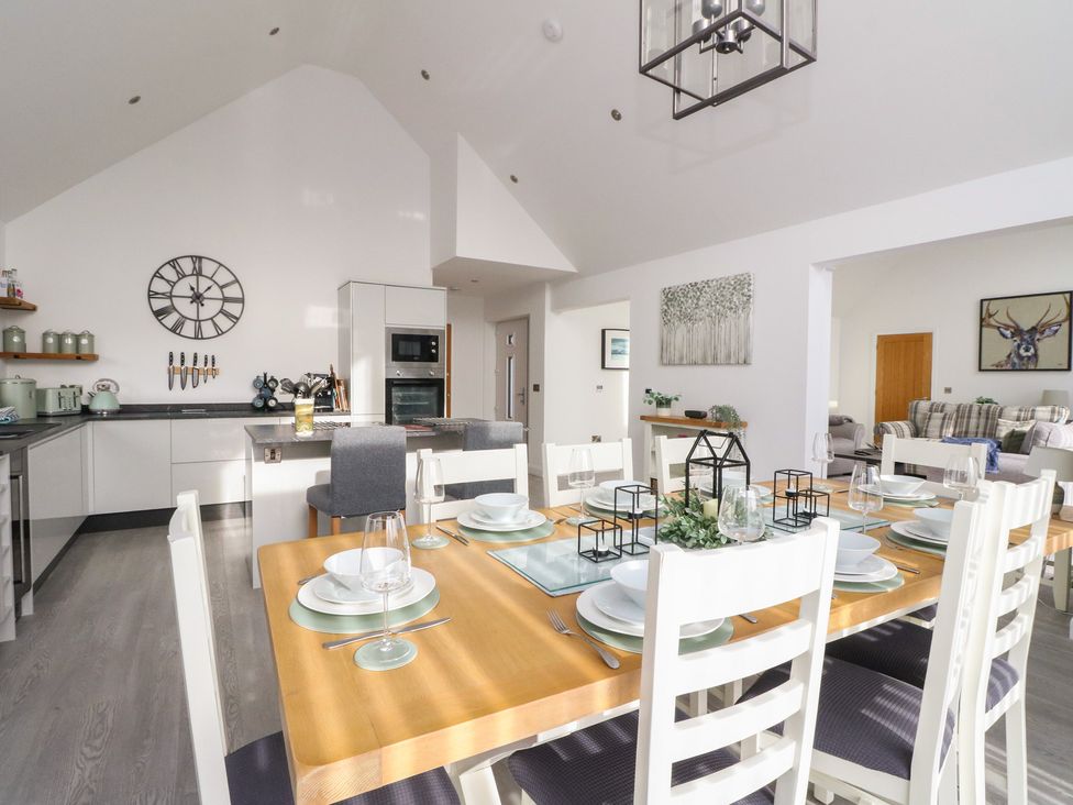 A dining room with a table and chairs at Eildan in Fort William