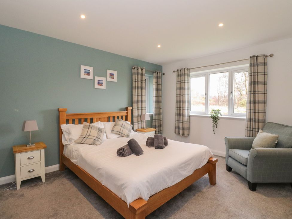 A bedroom with a bed and nightstand at Eildan in Fort William