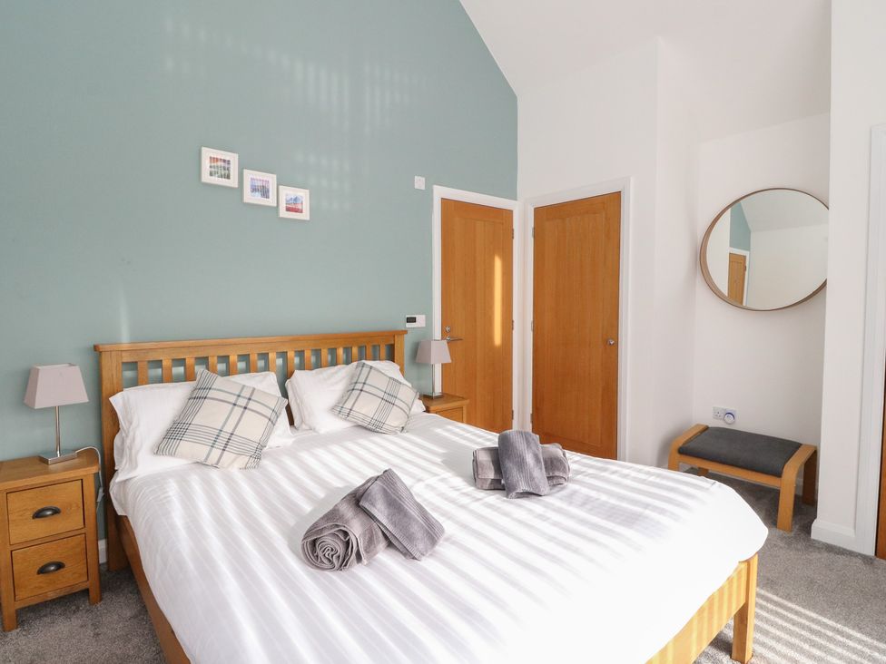 A bedroom with a bed and bedside table at Eildan in Fort William