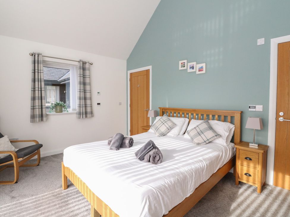 A bedroom with a bed and bedside table at Eildan in Fort William