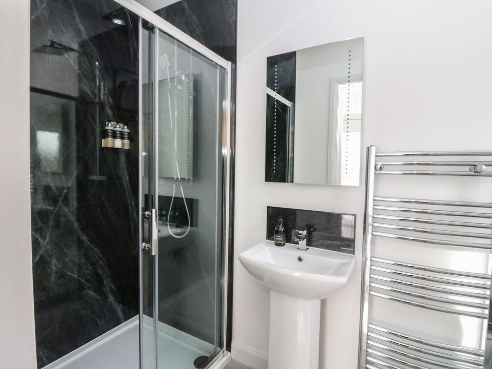 A bathroom with a shower, sink, and towel radiator at Eildan in Fort William