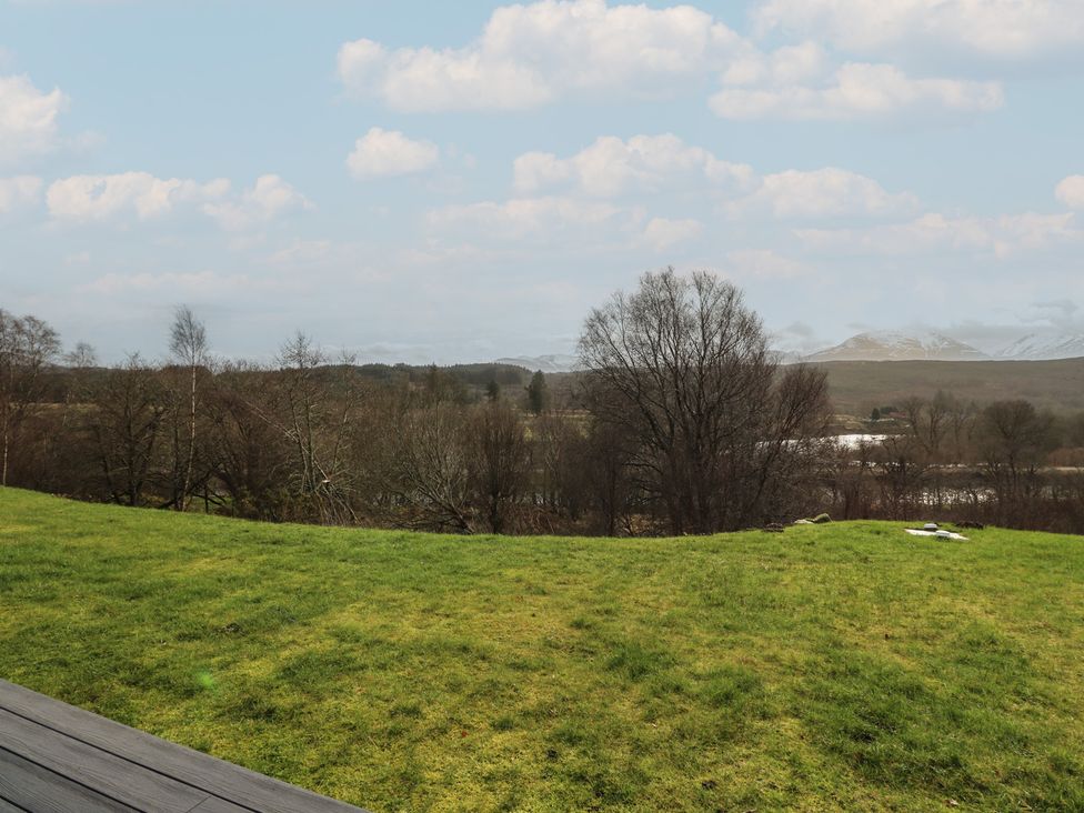 An outdoor view of grass and trees with hills in the background at Eildan, Fort William