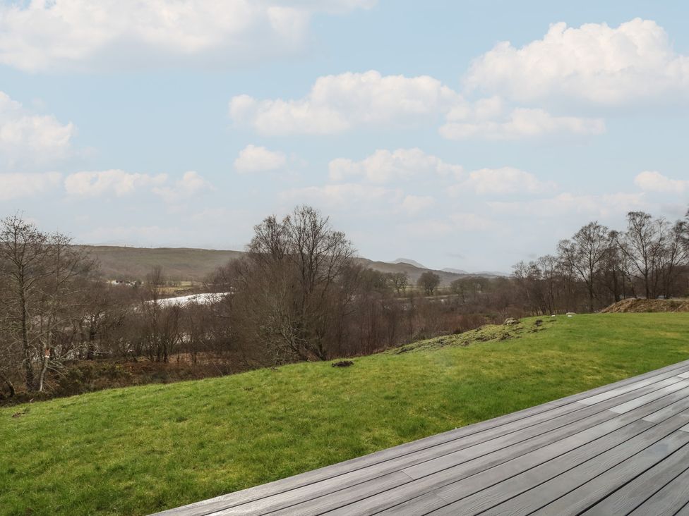 A view of grass and trees with hills in the background at Eildan, Fort William