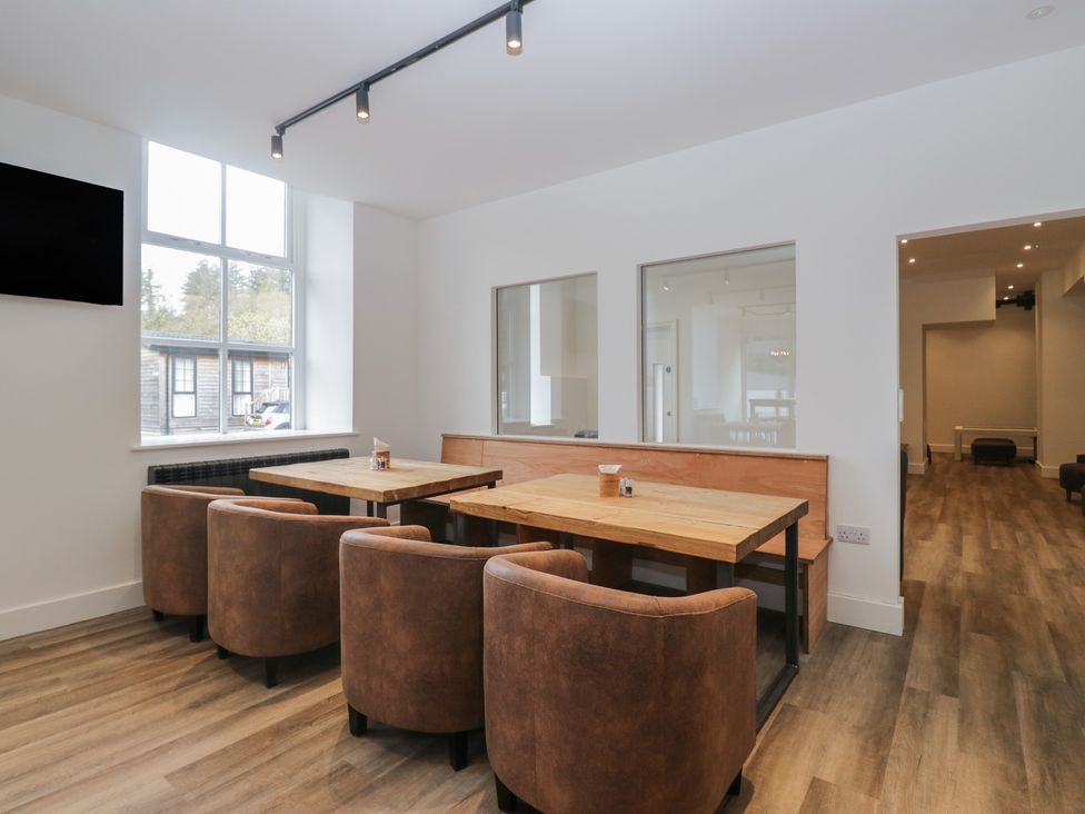 A dining room with tables and chairs at Riverside Cottage No 5 Keswick