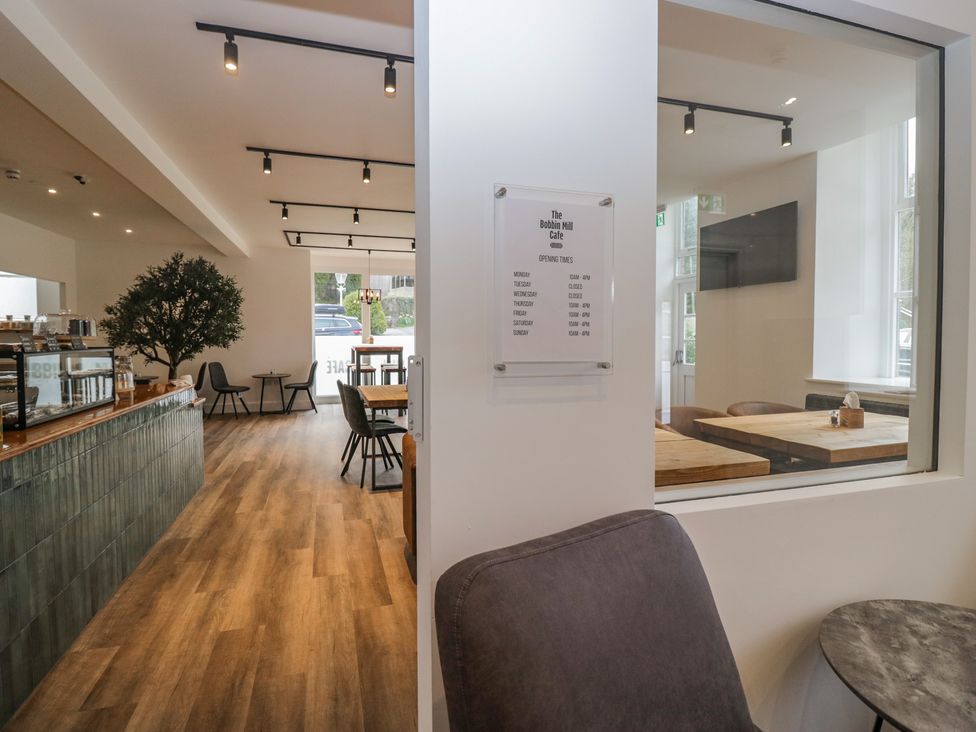 A café interior with tables and chairs at Greta House in Keswick