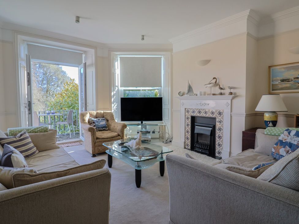 A living room with a television and coffee table at 2 St Michaels House in Lyme Regis