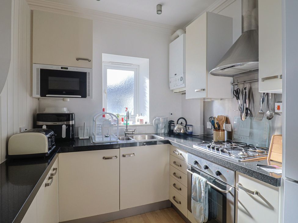 A kitchen with stove and appliances at 2 St Michaels House in Lyme Regis