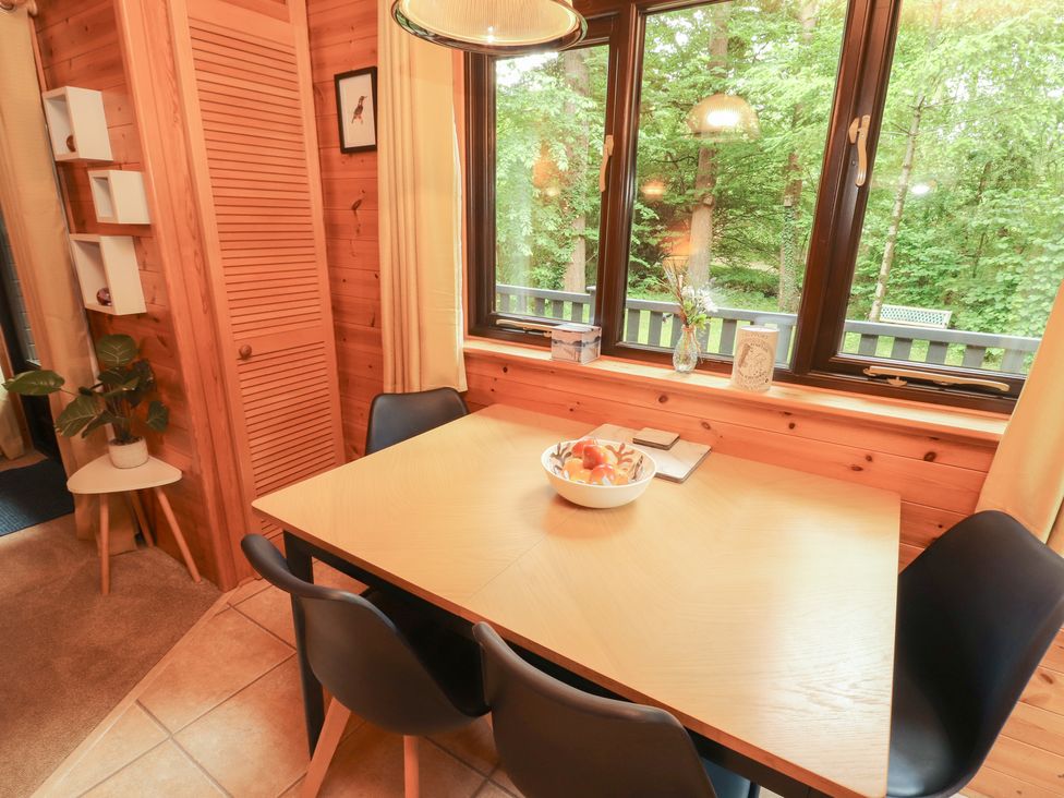 A dining room with a table and chairs at Derwent Lodge in Keswick