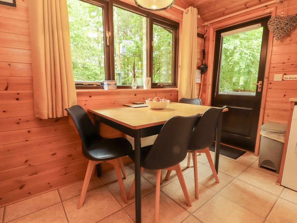 A dining room with a table and chairs at Derwent Lodge in Keswick