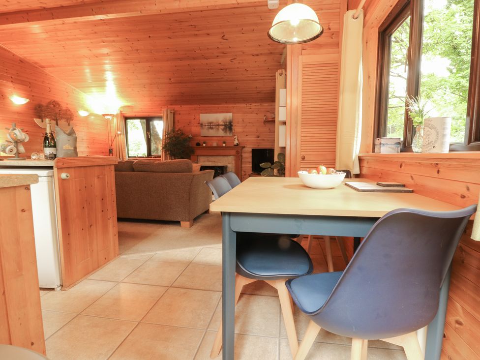 A dining area with a table and chairs at Derwent Lodge in Keswick