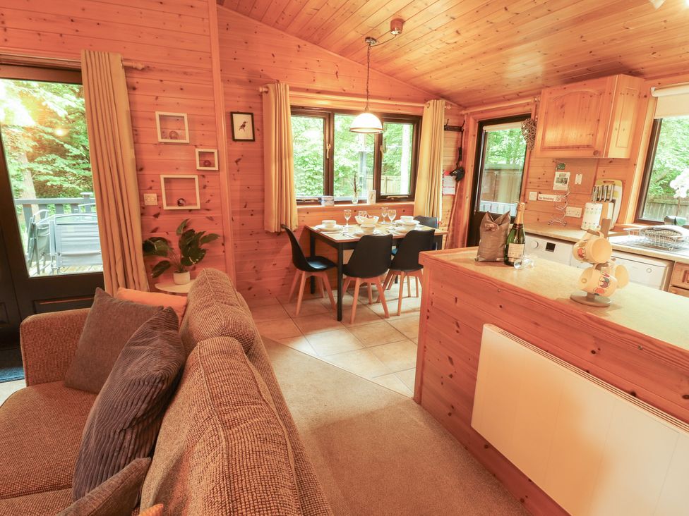 A kitchen with a dining table and chairs at Derwent Lodge in Keswick