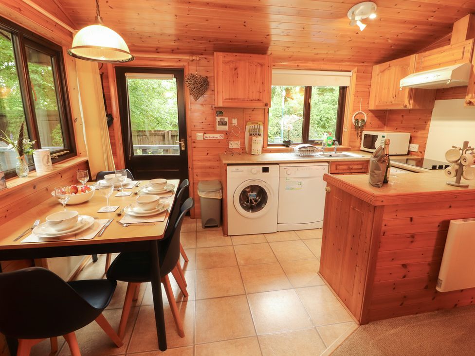 A kitchen with a table set for dinner at Derwent Lodge in Keswick