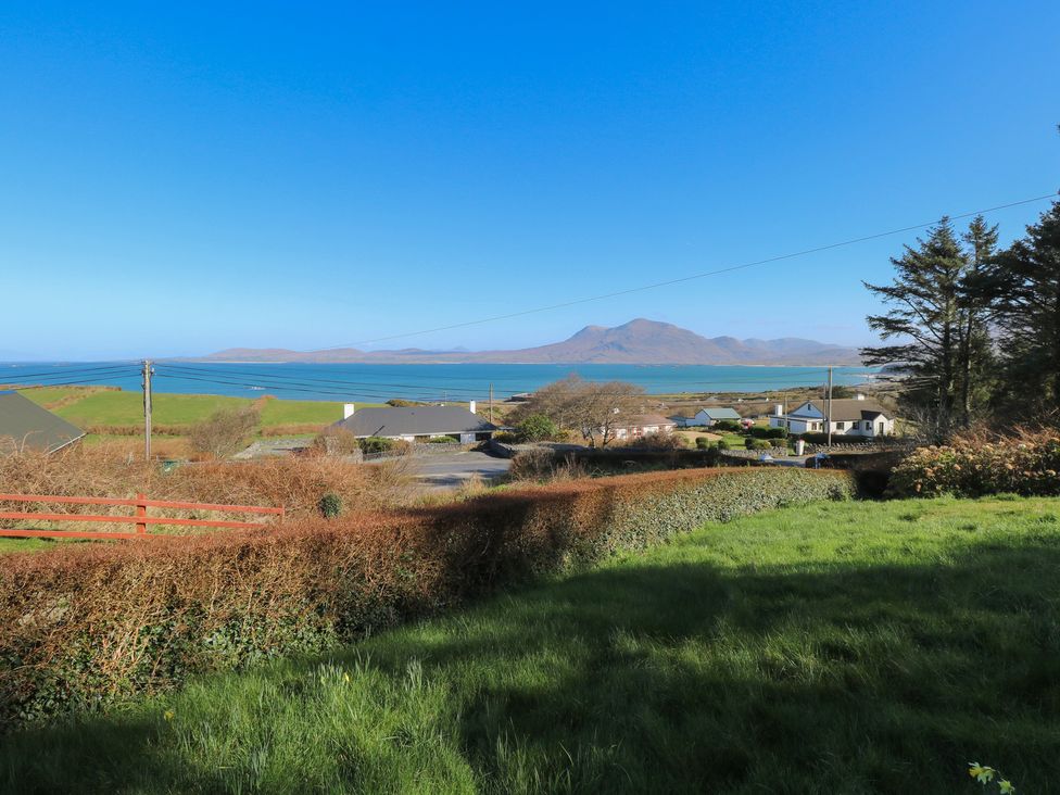 A view of the ocean and mountains from a garden at Sea View House in Tully, County Galway