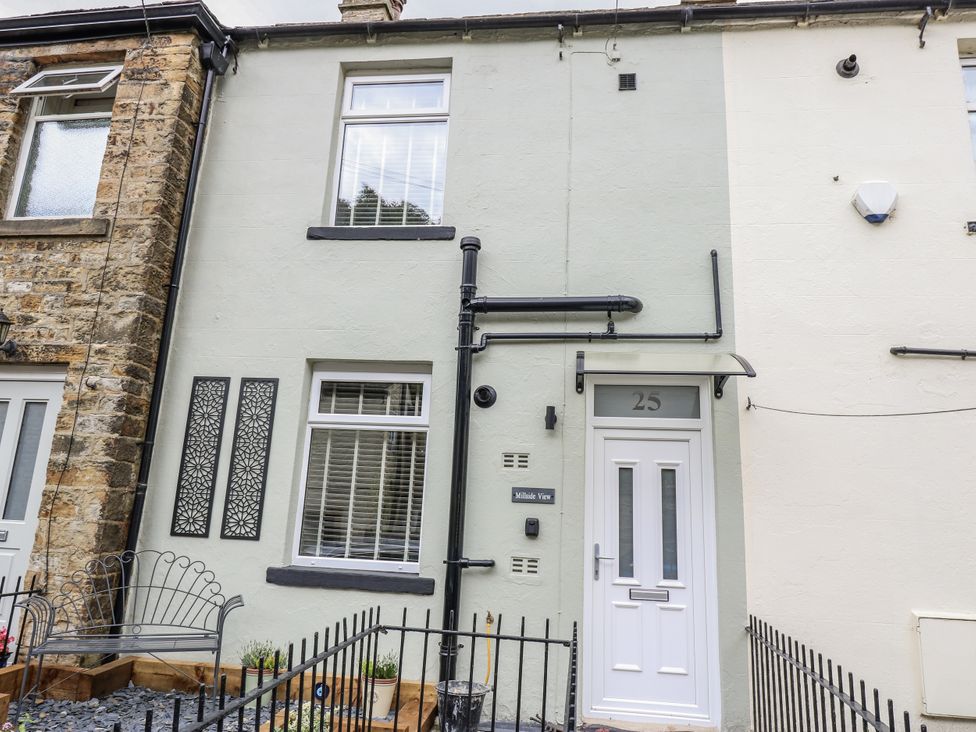 A house exterior with front door and decorative panel at Millside View