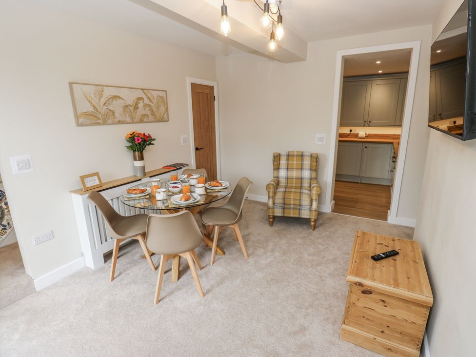 A dining room with a table set for meals at Millside View